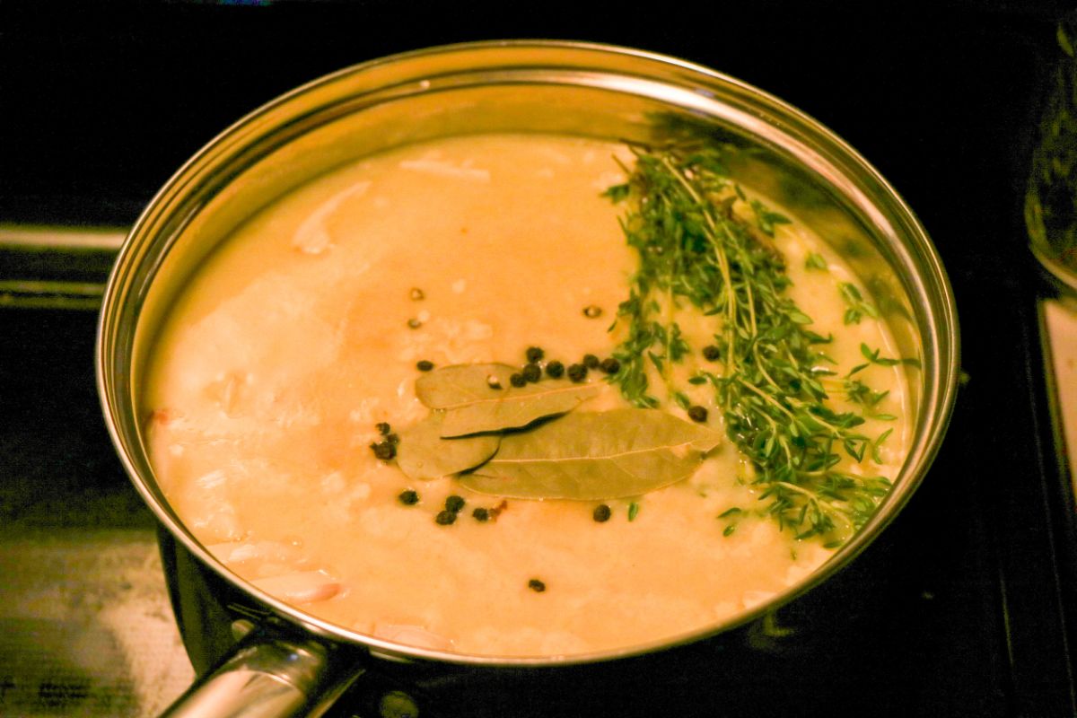 Water, orange juice, brown sugar, salt, garlic, thyme, bay leaves, and peppercorns in a large saucepan.