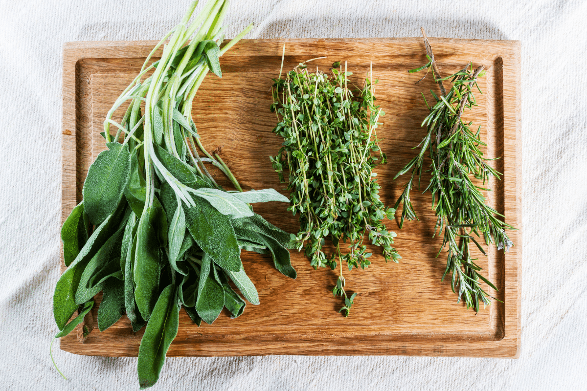 Fresh Herbs on a wooden chopping board.