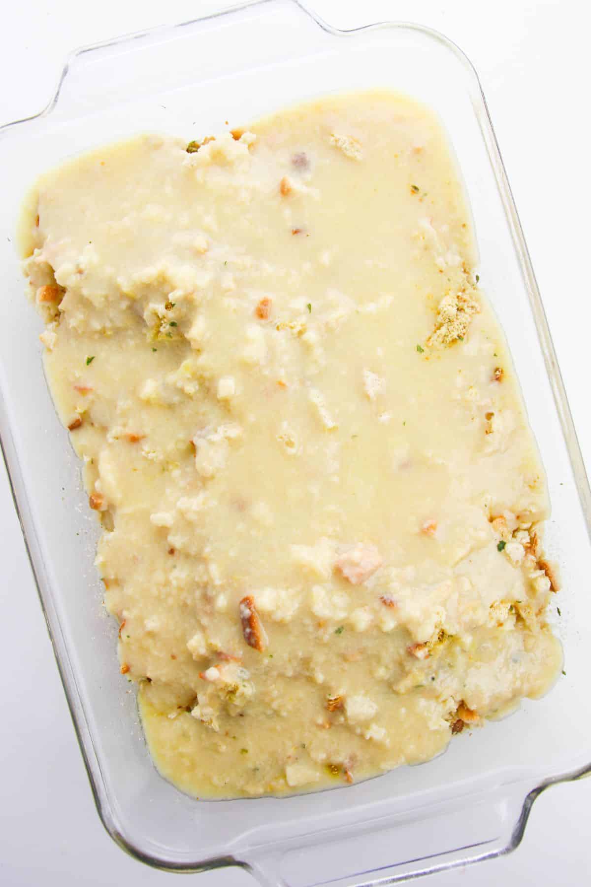 Chicken with sauce mixture in a casserole dish.