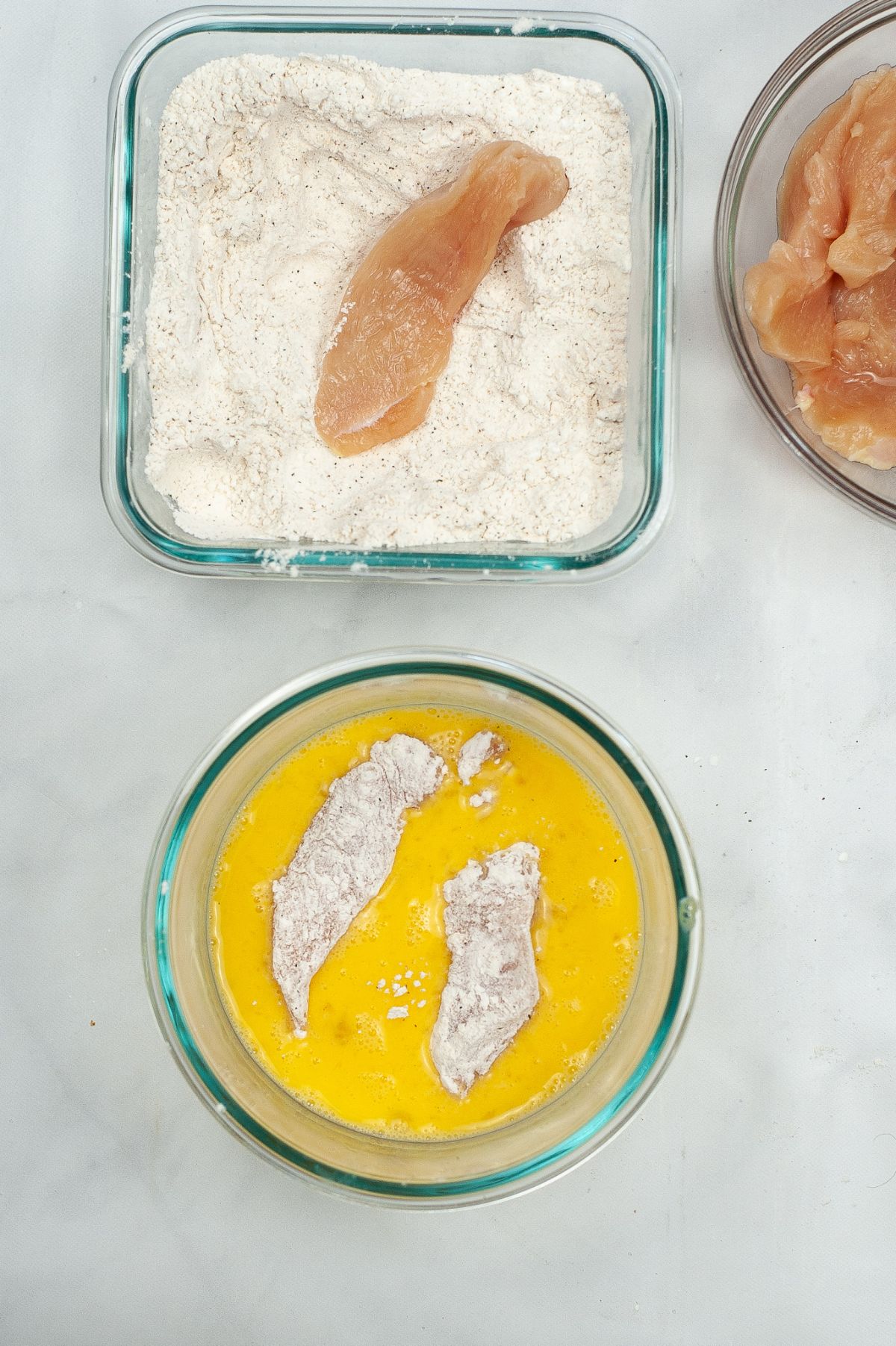 Chicken strips dipped in egg and flour mixture.