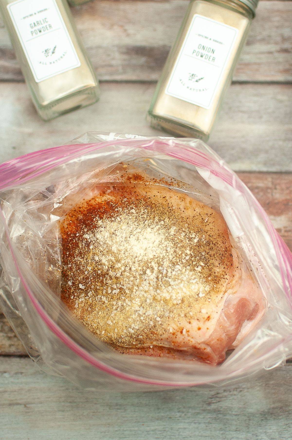 Pork with seasoning inside the zip lock bag.