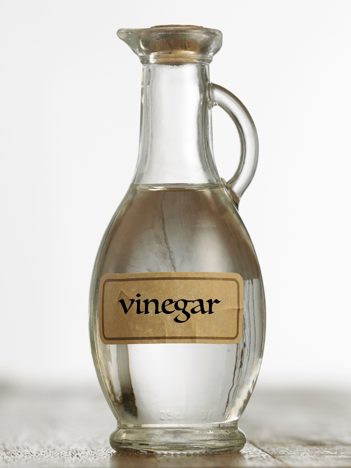 Close-up view of white vinegar in a bottle.