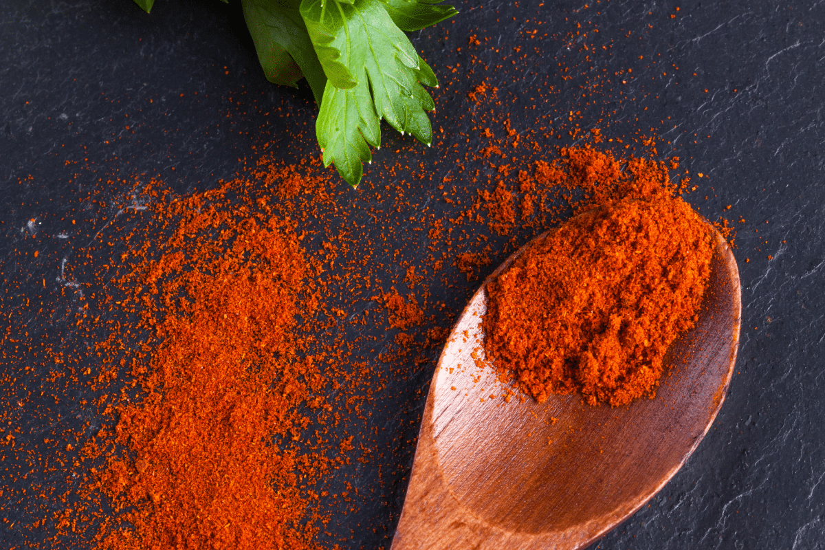 Smoked paprika on a wooden spoon.