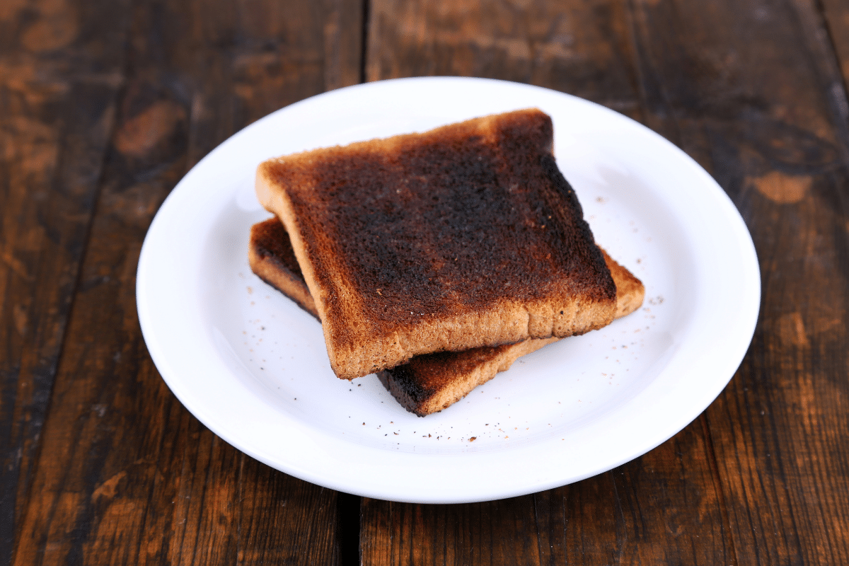 Burnt bread on a white plate.