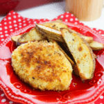 A red plate with baked panko pork chops.