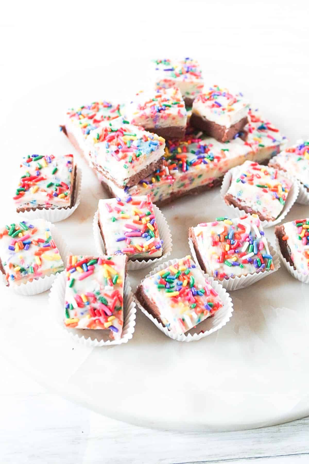 A Funfetti fudge with sprinkles on a serving plate.