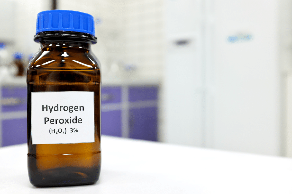 A bottle of hydrogen peroxide sits on a table.