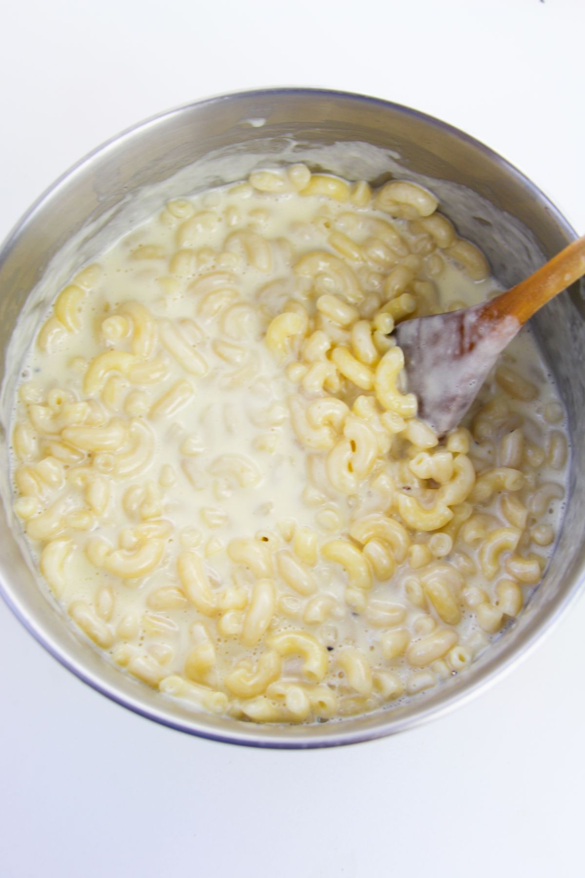 Macaroni pasta and cheese mixture in a saucepan.