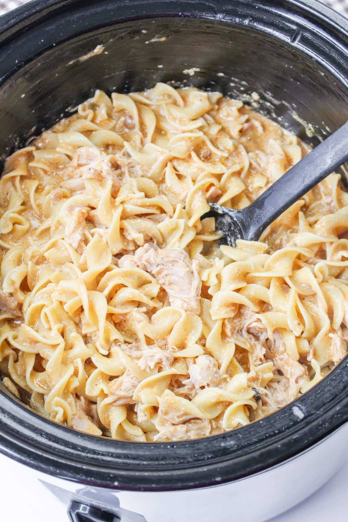 Chicken and noodles in a crockpot.