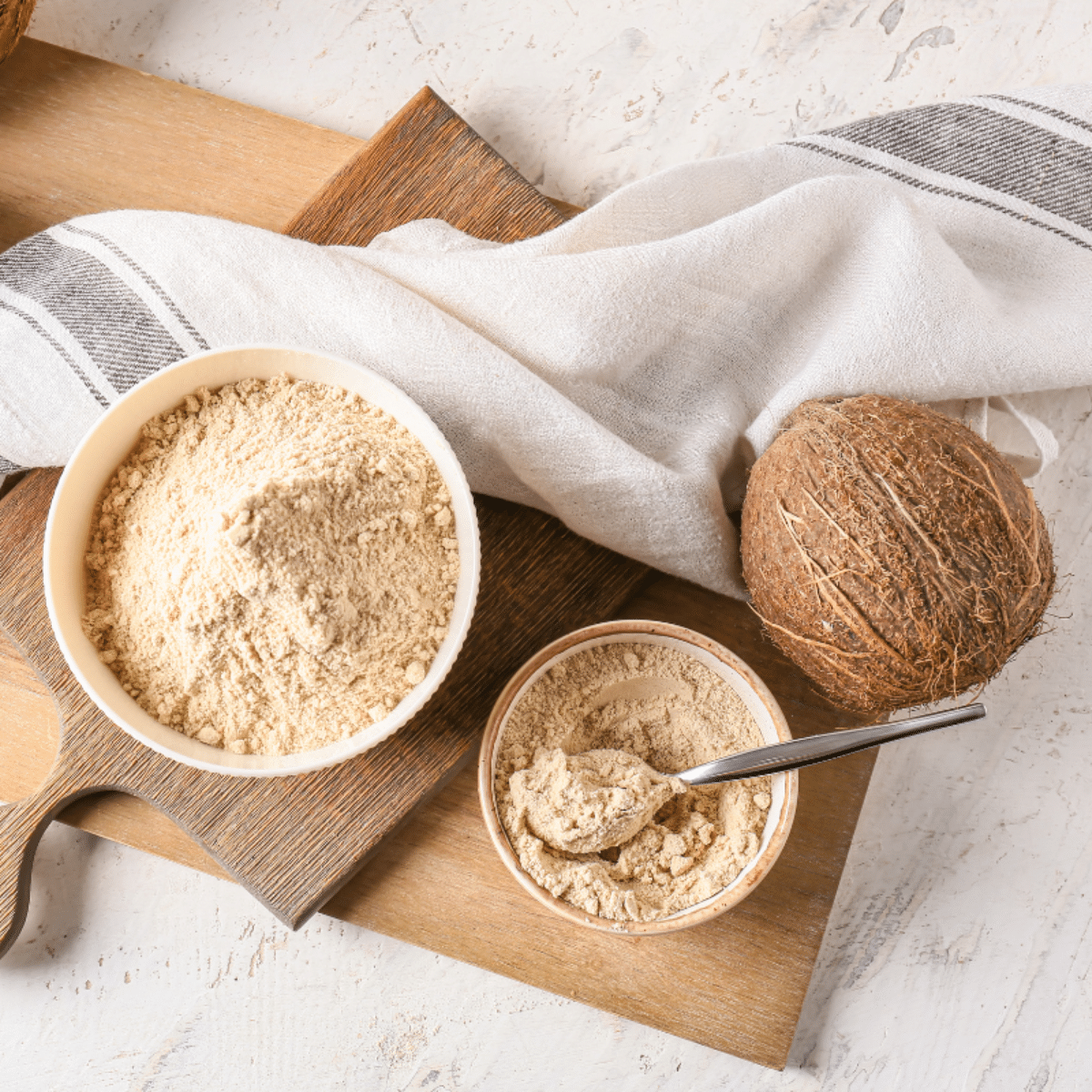 A substitute for coconut flour, a spoon on a wooden cutting board.