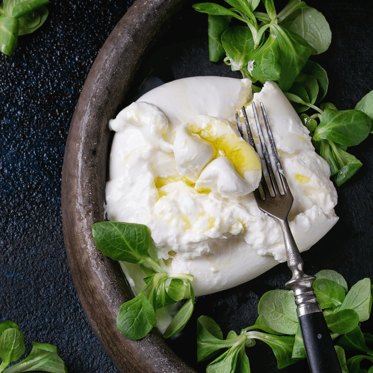Fresh mozzarella on a plate, a substitute for burrata cheese.