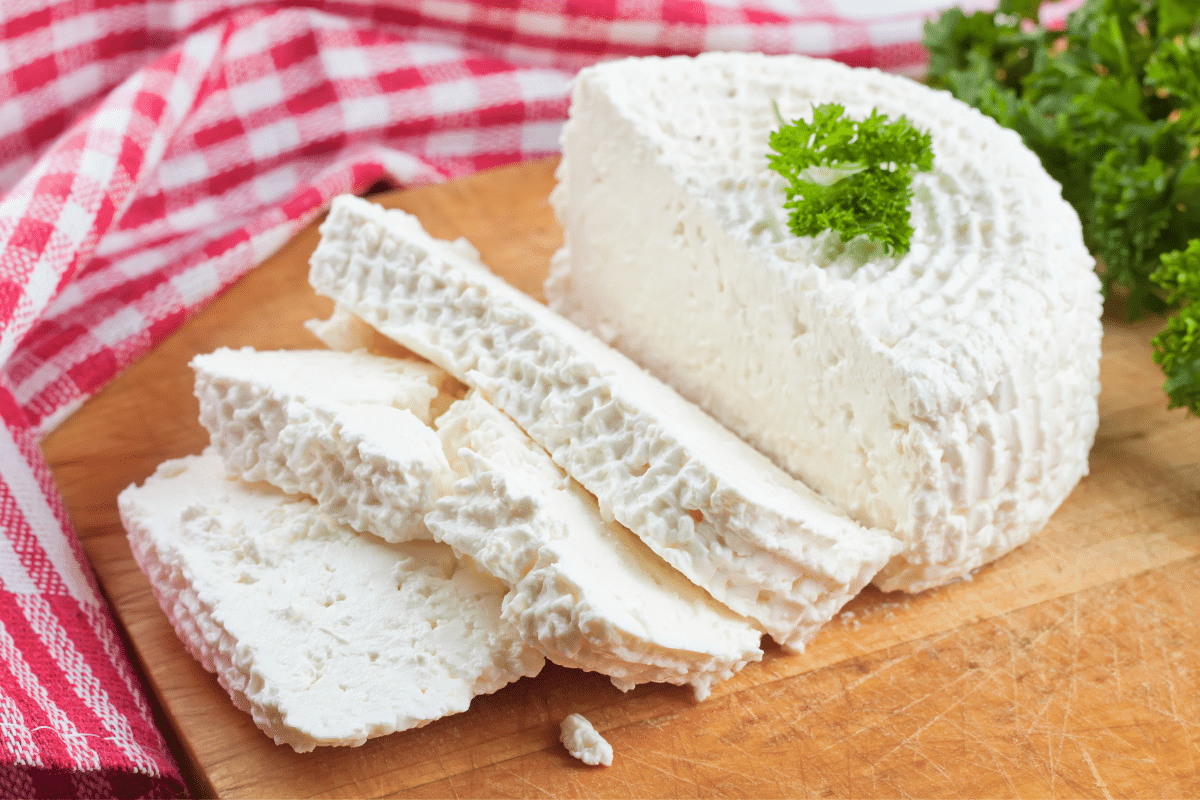 cottage cheese on a wooden board, garnished with parsley.