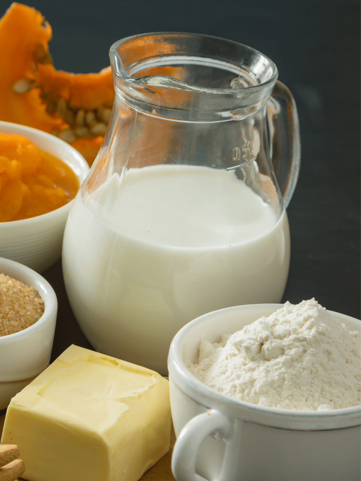 Ingredients for pumpkin pie with evaporated milk in a glass jar.