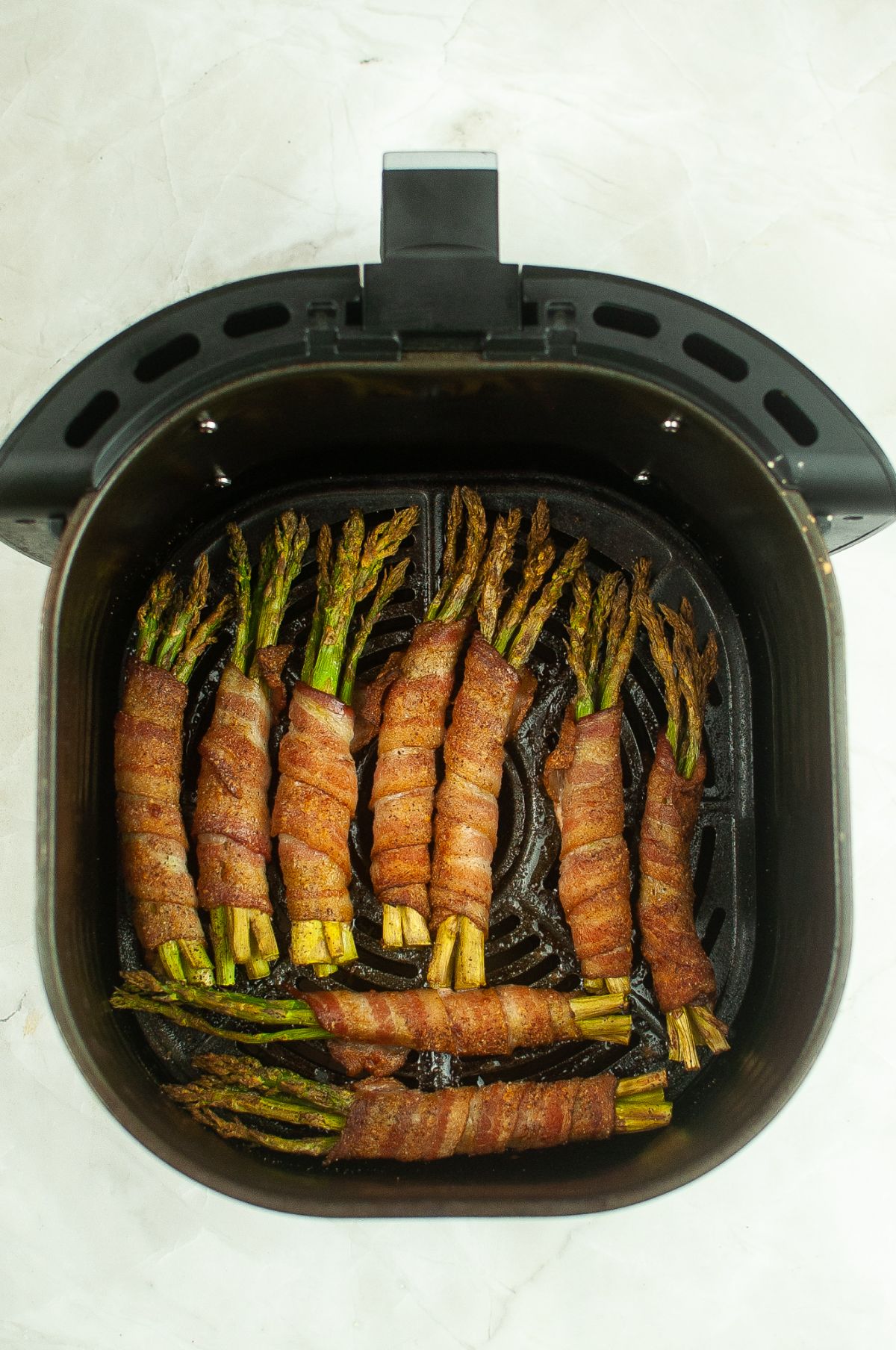 Bacon wrapped asparagus inside the Air Fryer.