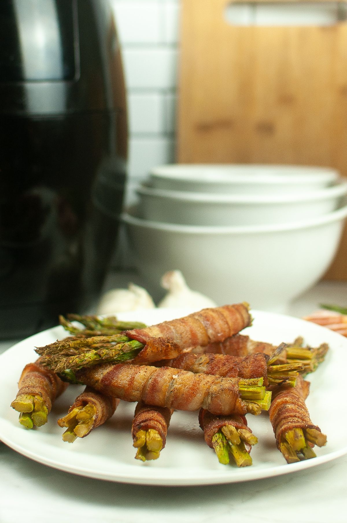 Air fryer bacon wrapped asparagus on a plate.