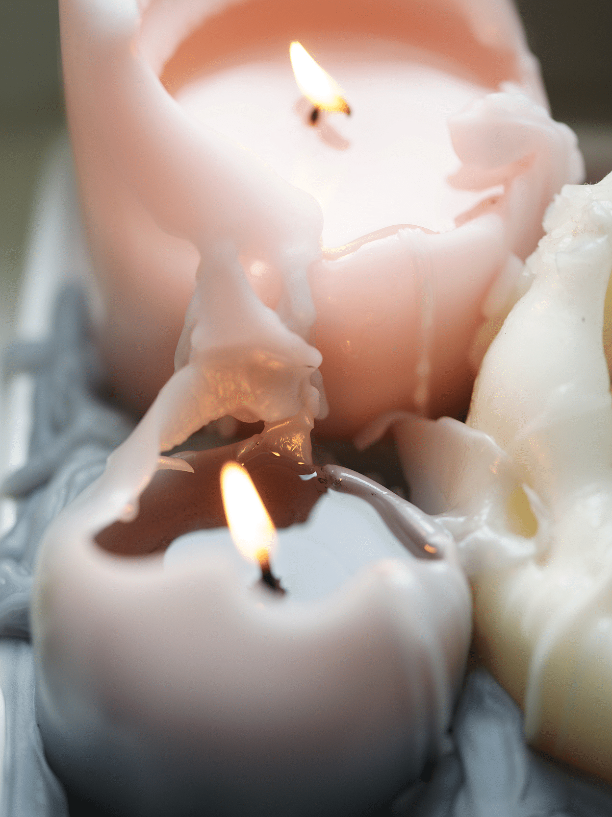 a closeup of three candles on a tray.