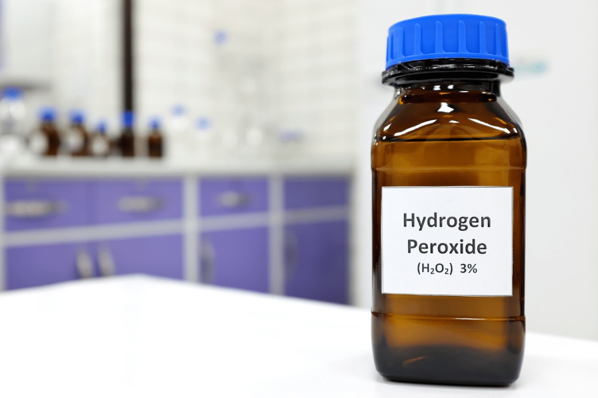 A bottle of hydrogen peroxide used to remove red wine stains from the carpet.