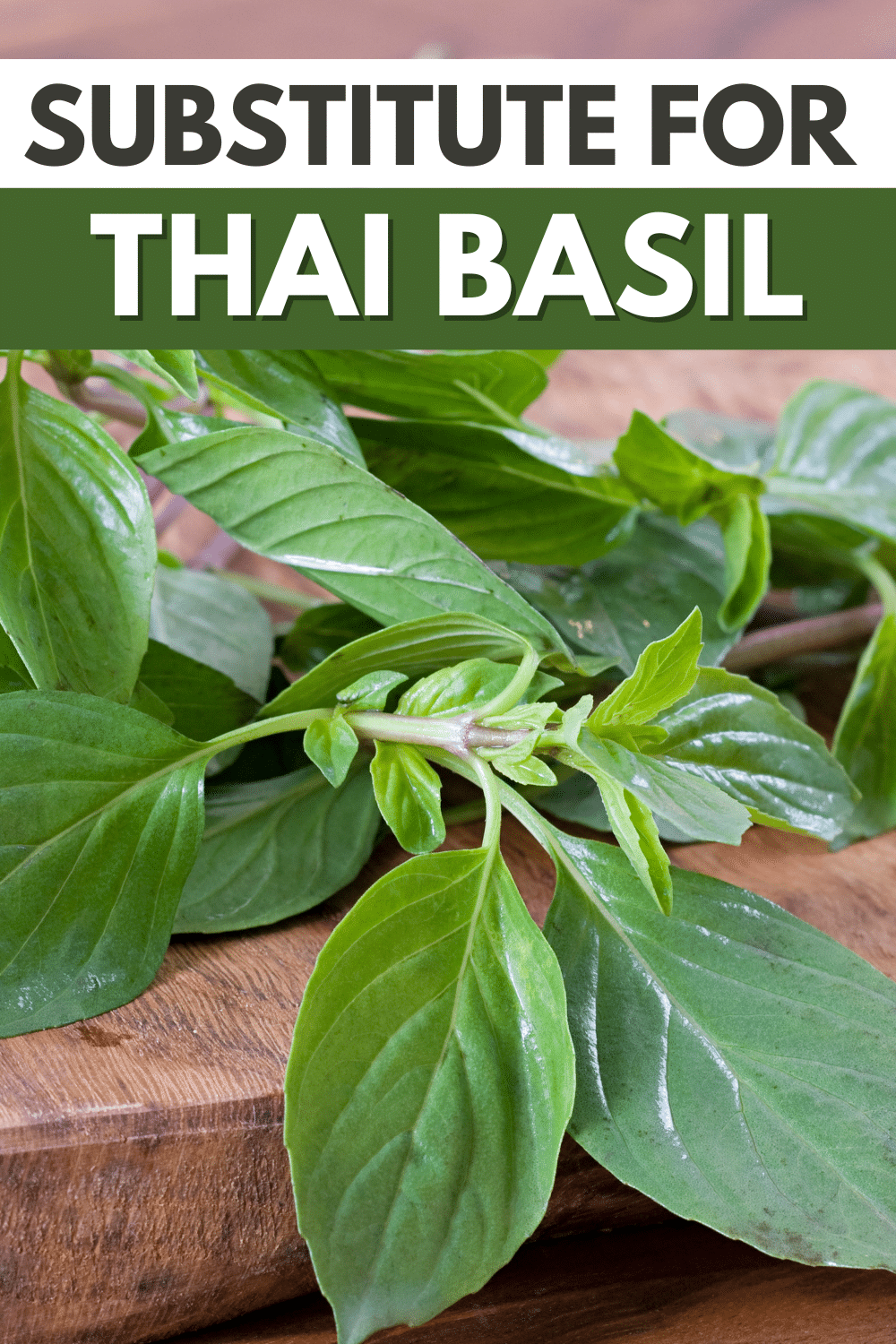Thai basil leaves on a cutting board with the text Thai basil substitute.