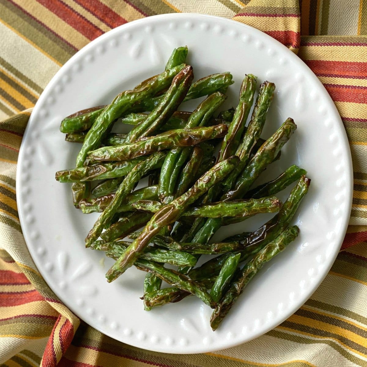 Grilled green beans on a plate.