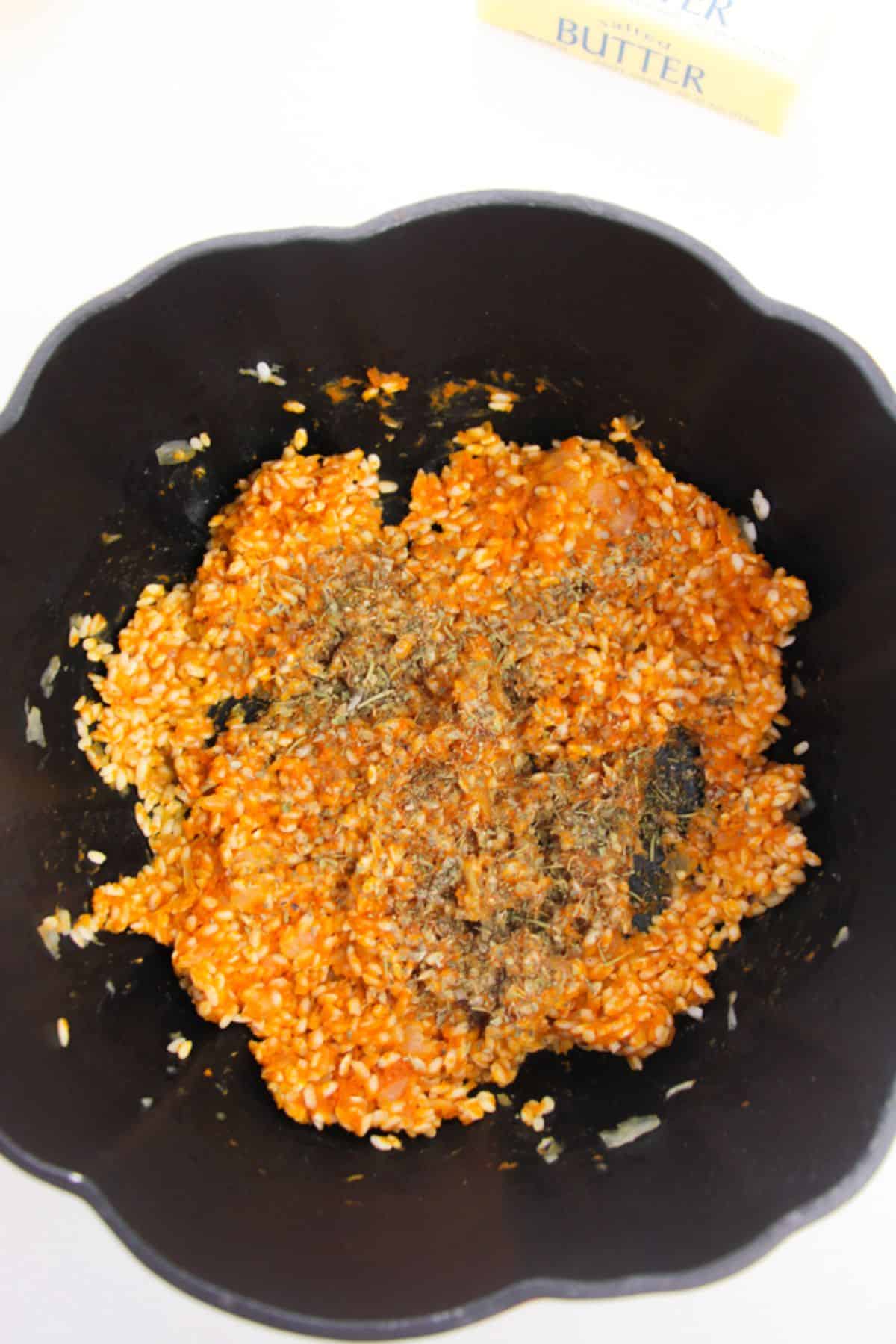 Pumpkin puree and seasoning are added to the rice mixture.