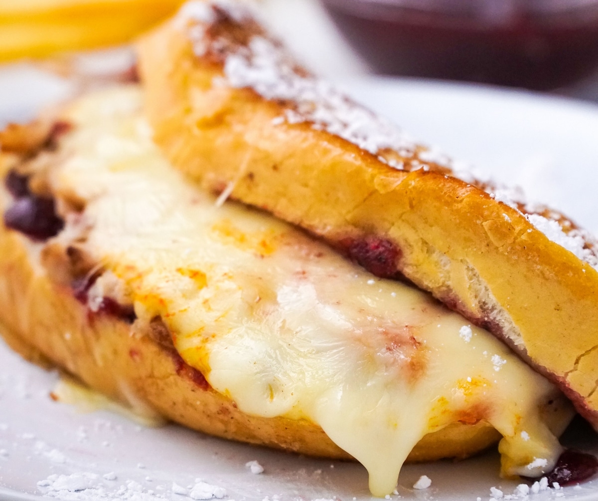 A french toast with cheese and berries on a plate.
