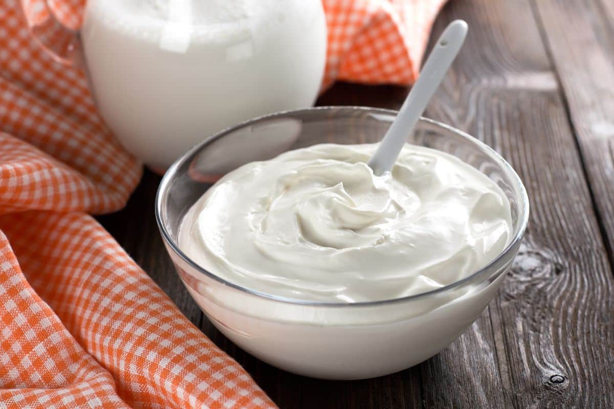 Sour Cream in a bowl on a wooden table.