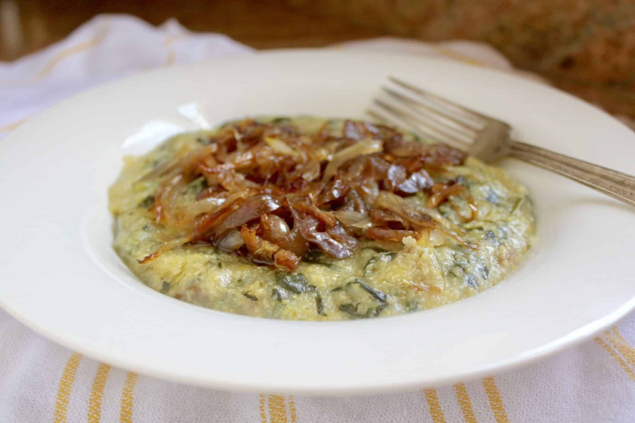 A plate of spinach and onion omelet with a fork.