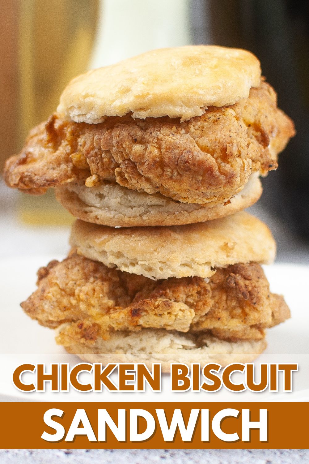 A stack of Chicken Biscuit Sandwiches with the text "Chicken Biscuit Sandwich.
