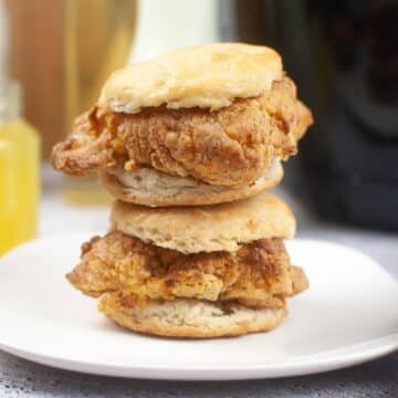 A stack of Chicken Biscuits on a plate.