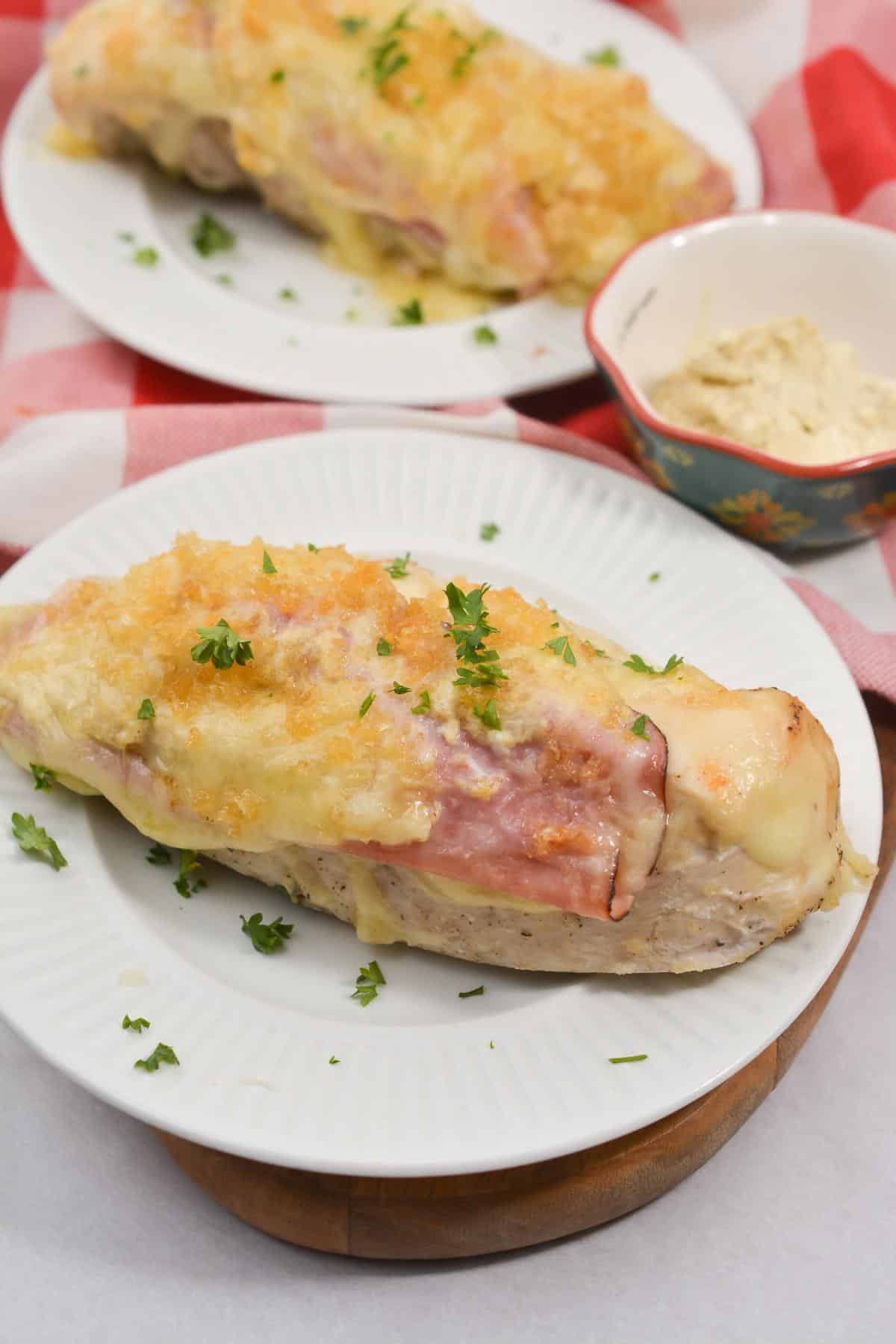 Chicken cordon bleu on a serving plate, garnished with parsley.