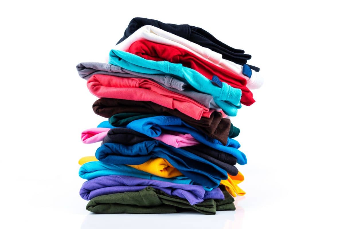 A pile of colorful t-shirts on a white background, perfect for minute to win it games for teens.