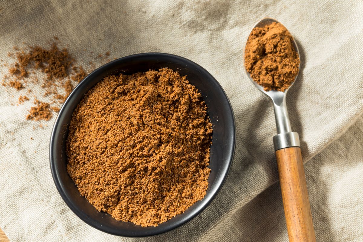 Garam Masala substitute for curry powder in a bowl next to a spoon.