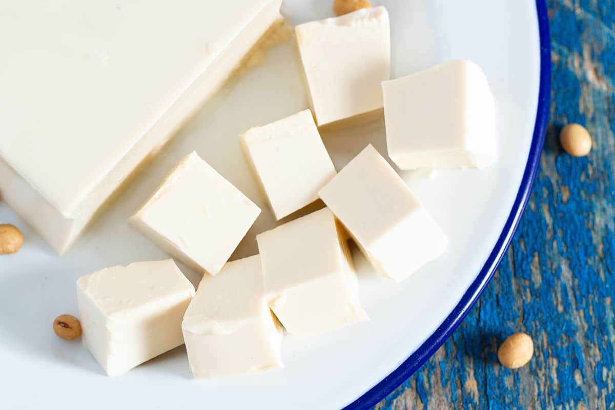 Soft tofu on a plate, a Greek Yogurt Substitute.