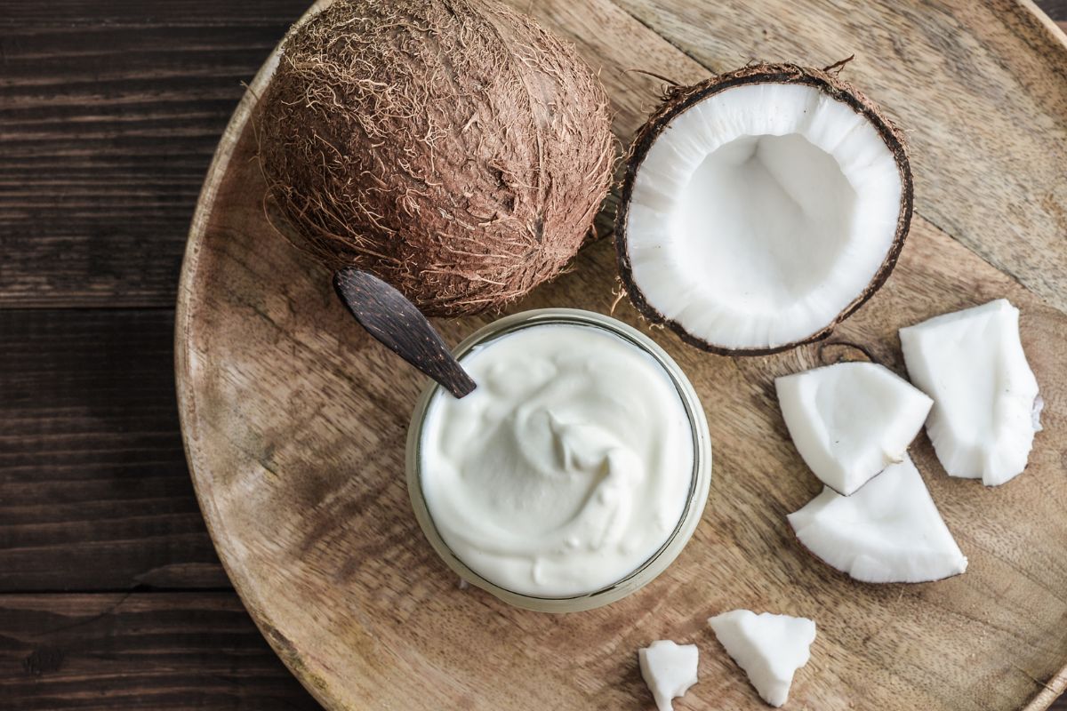 Coconut cream, a delicious Greek yogurt substitute, beautifully presented on a wooden plate.