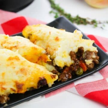 A hearty and flavorful Cast Iron Shepherd's Pie featuring mashed potatoes, meat, and vegetables served on a plate.