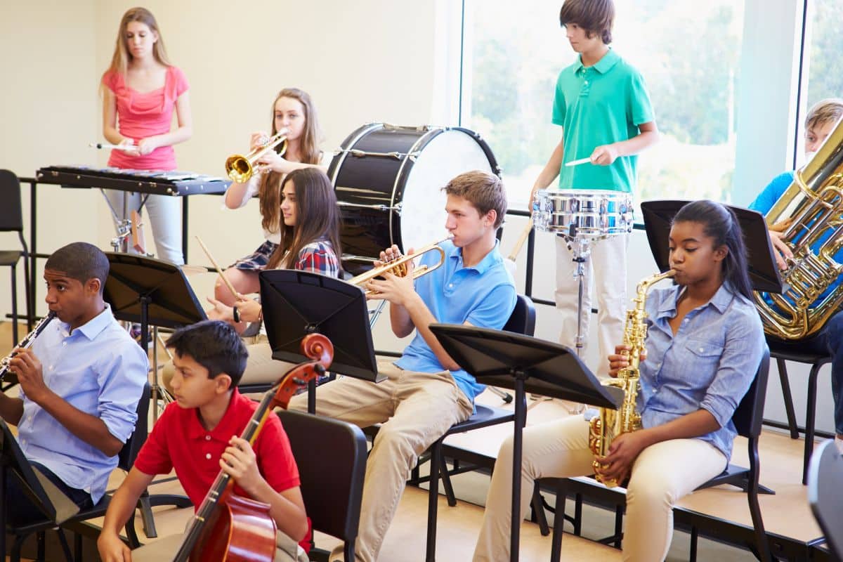 A group of teens playing musical instruments, an activity perfect for teenagers.