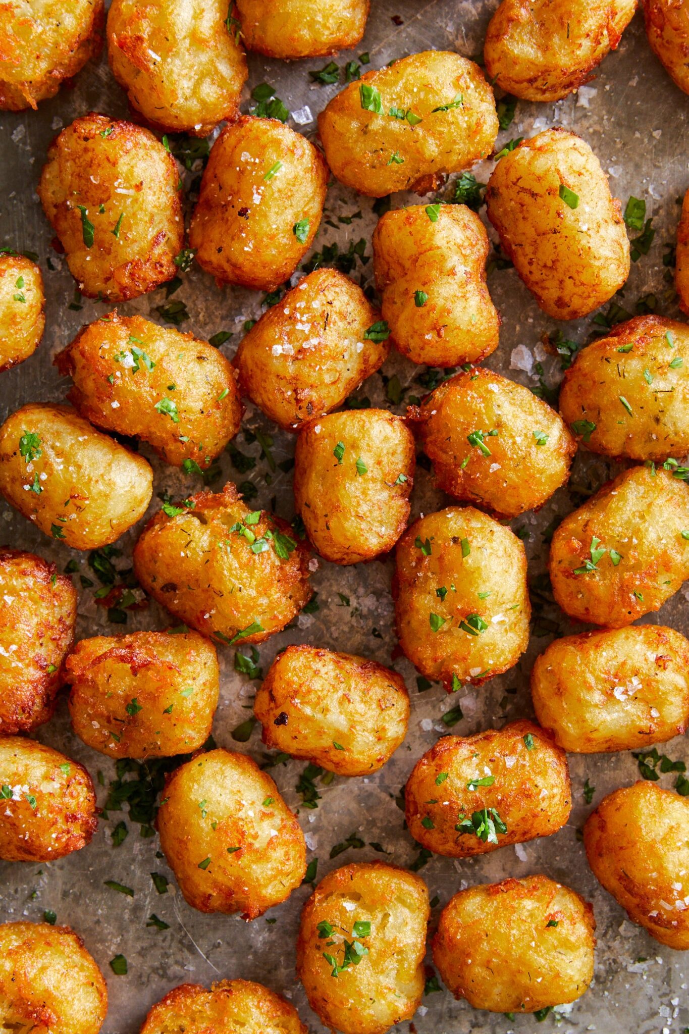 Fried tater tots on a baking sheet.
