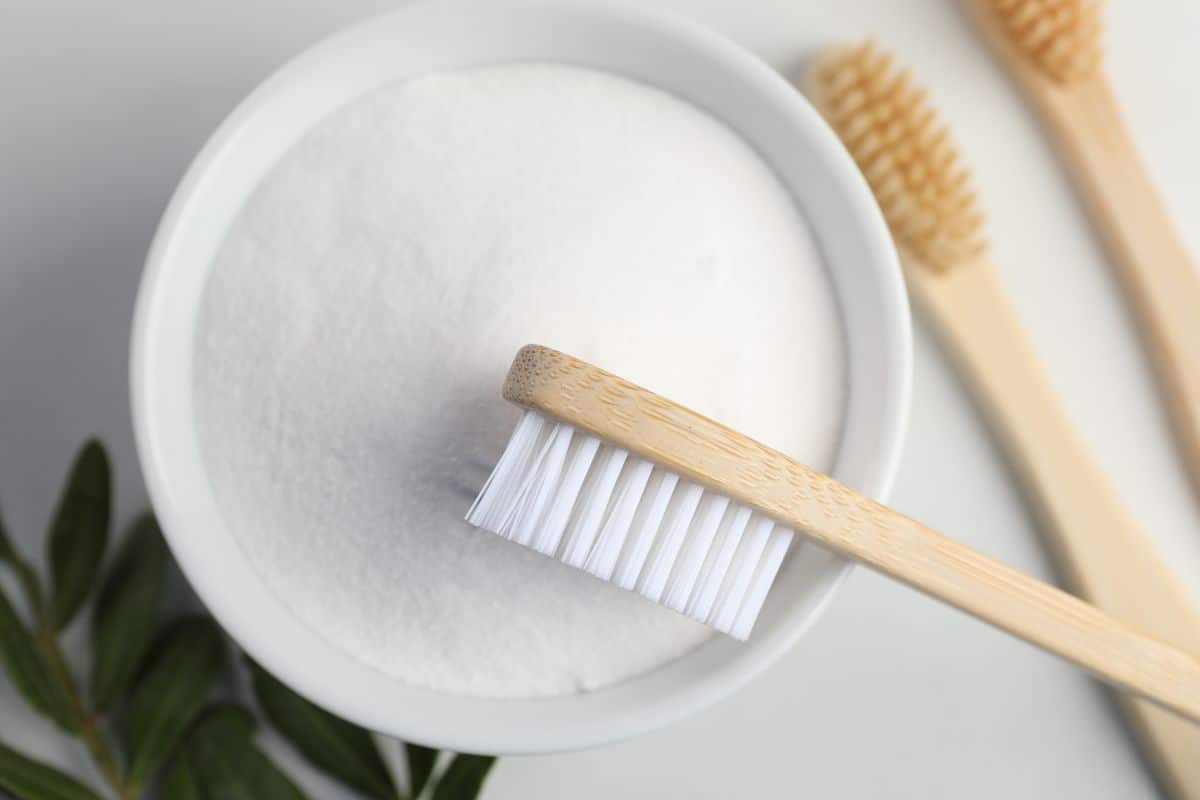 Baking soda in a bowl with a toothbrush.