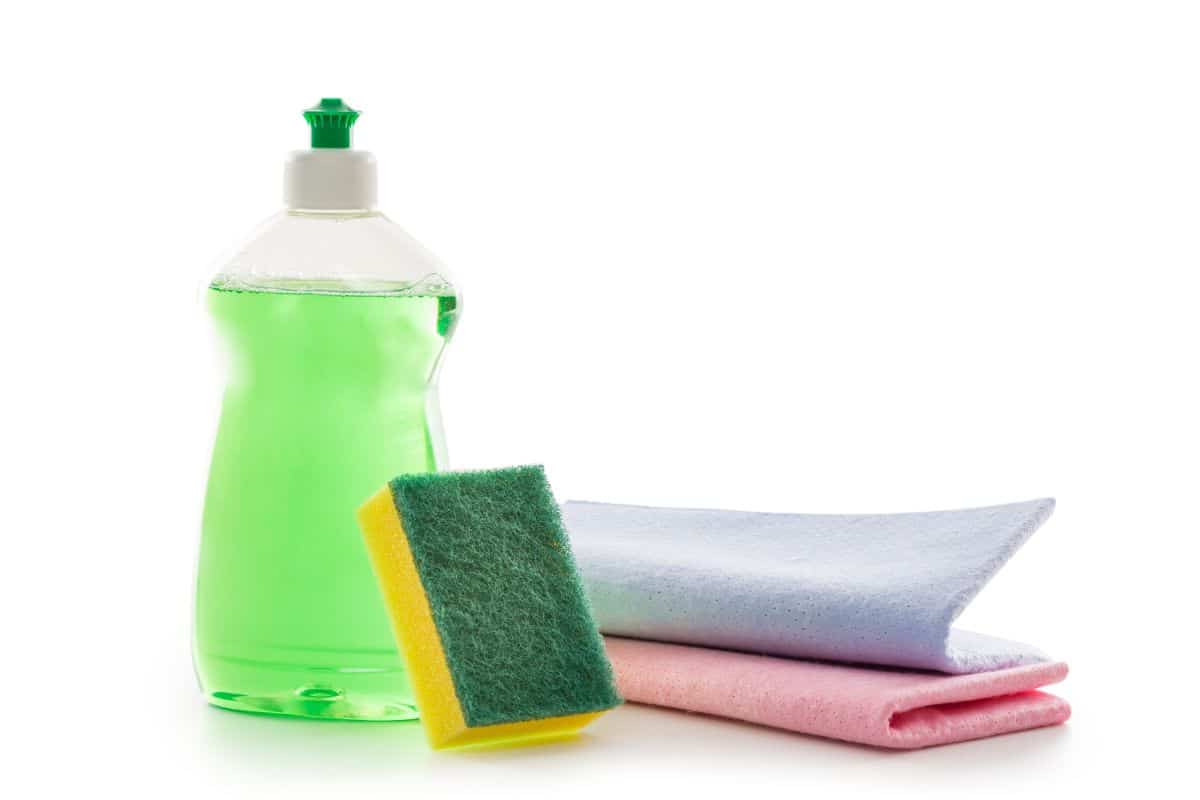 Bottle of dish soap, cloth and sponge on white background, for how to Get Milk Out of Carpet.
