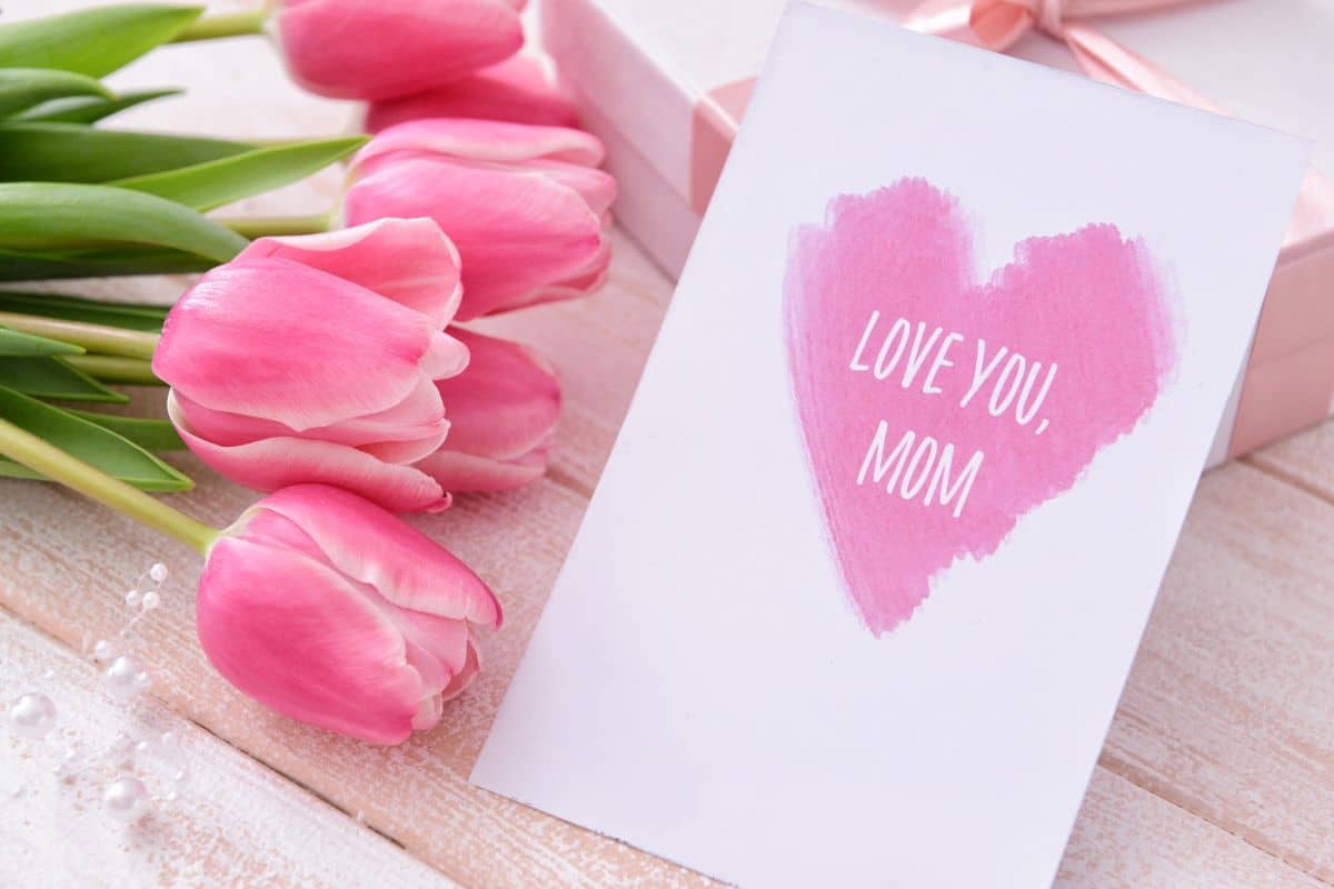 Missing you mom card with pink tulips and a gift box.