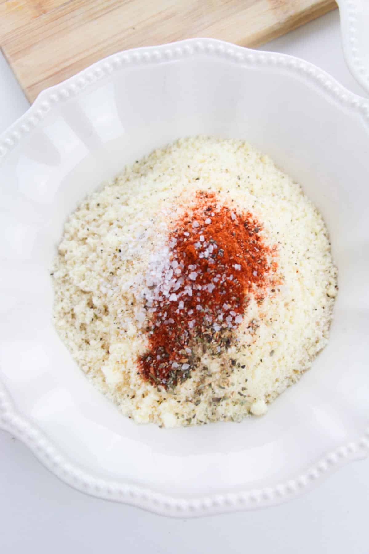 Panko breadcrumbs and seasonings in a white bowl.