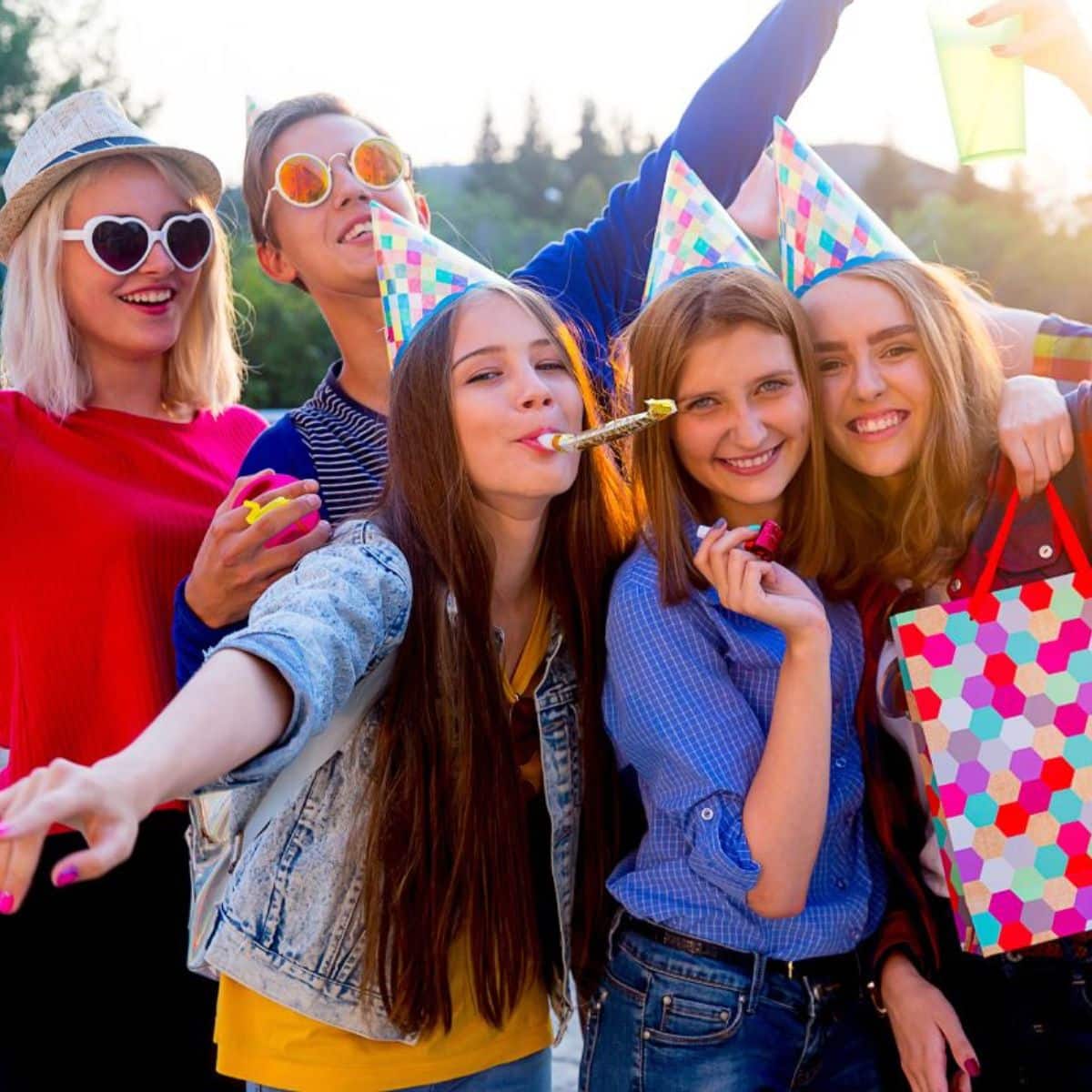 A group of friends having a birthday party with fun party theme ideas for teens.
