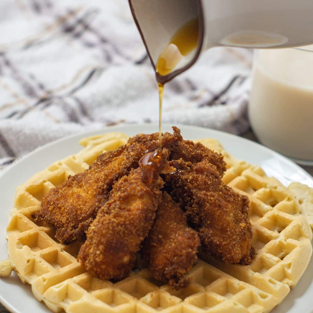 Southern Chicken and Waffles: Crispy fried chicken atop fluffy waffles, drizzled with syrup.