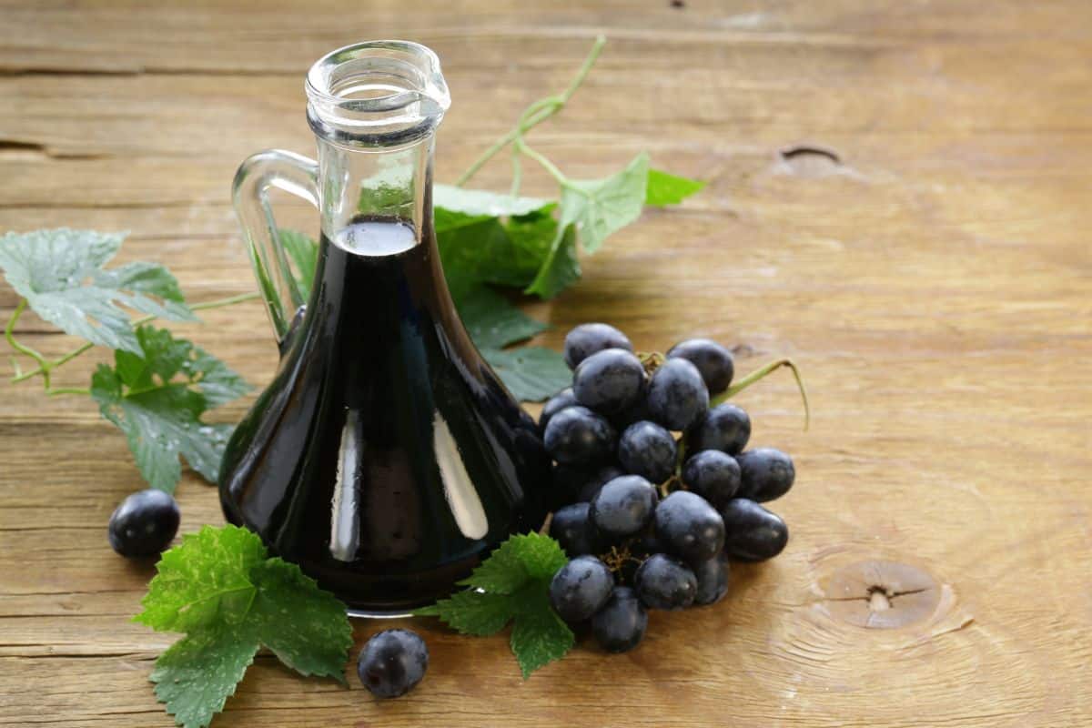 An alternative for sherry vinegar, a bottle of Balsamic vinegar on a wooden table.