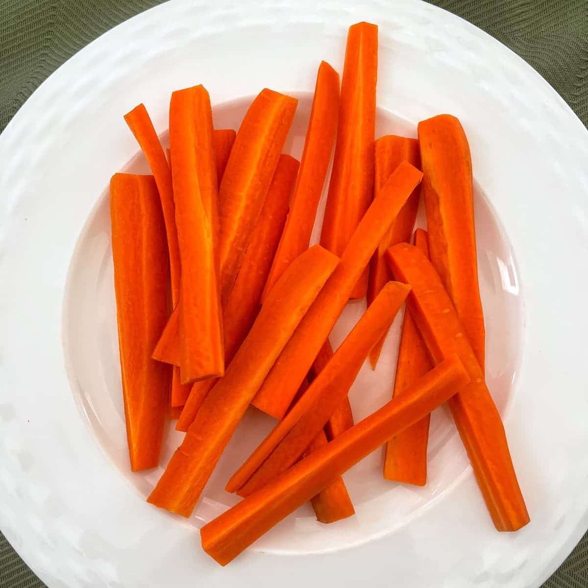 Sliced carrots on a white plate.