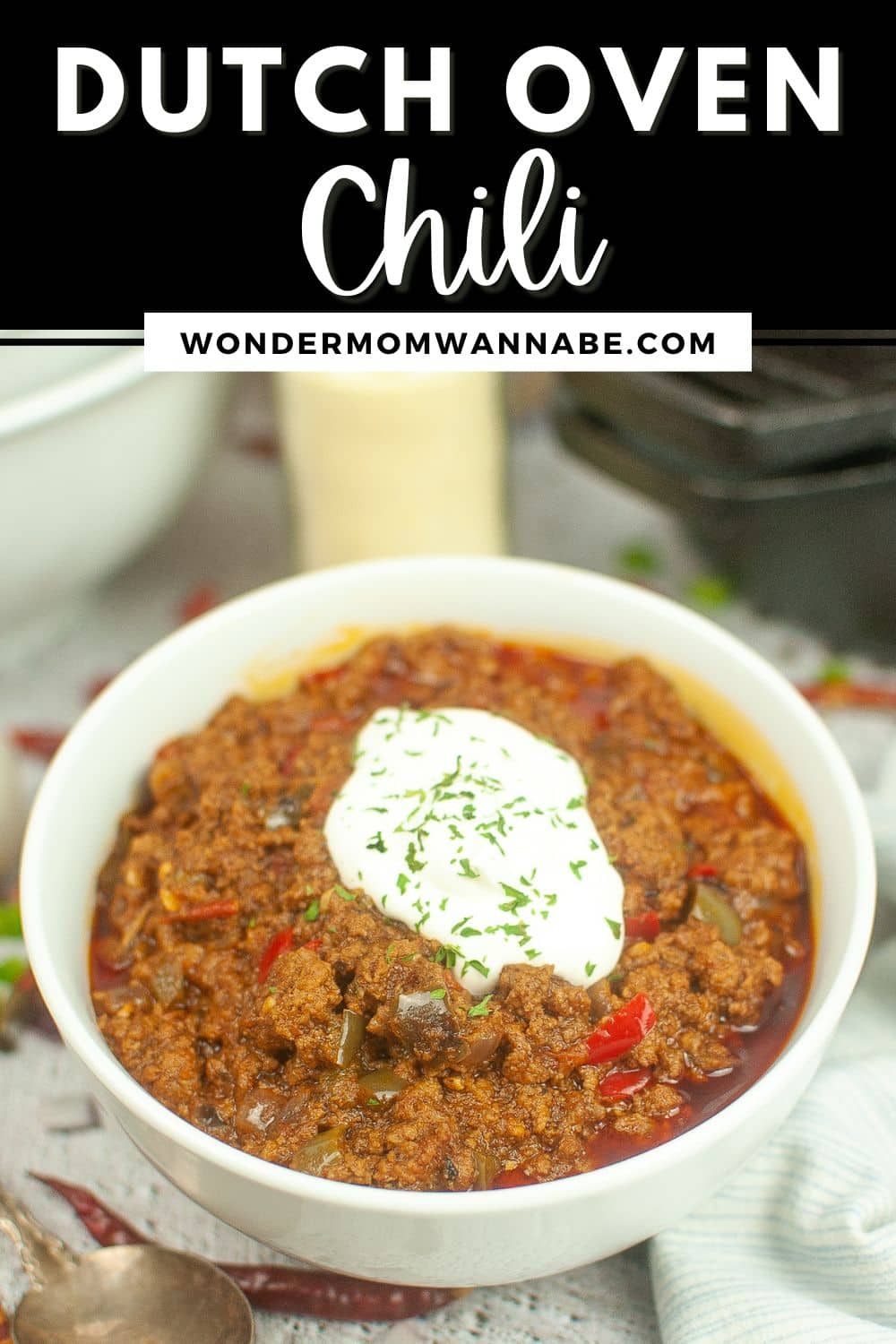 Dutch oven chili topped with sour cream in a bowl.