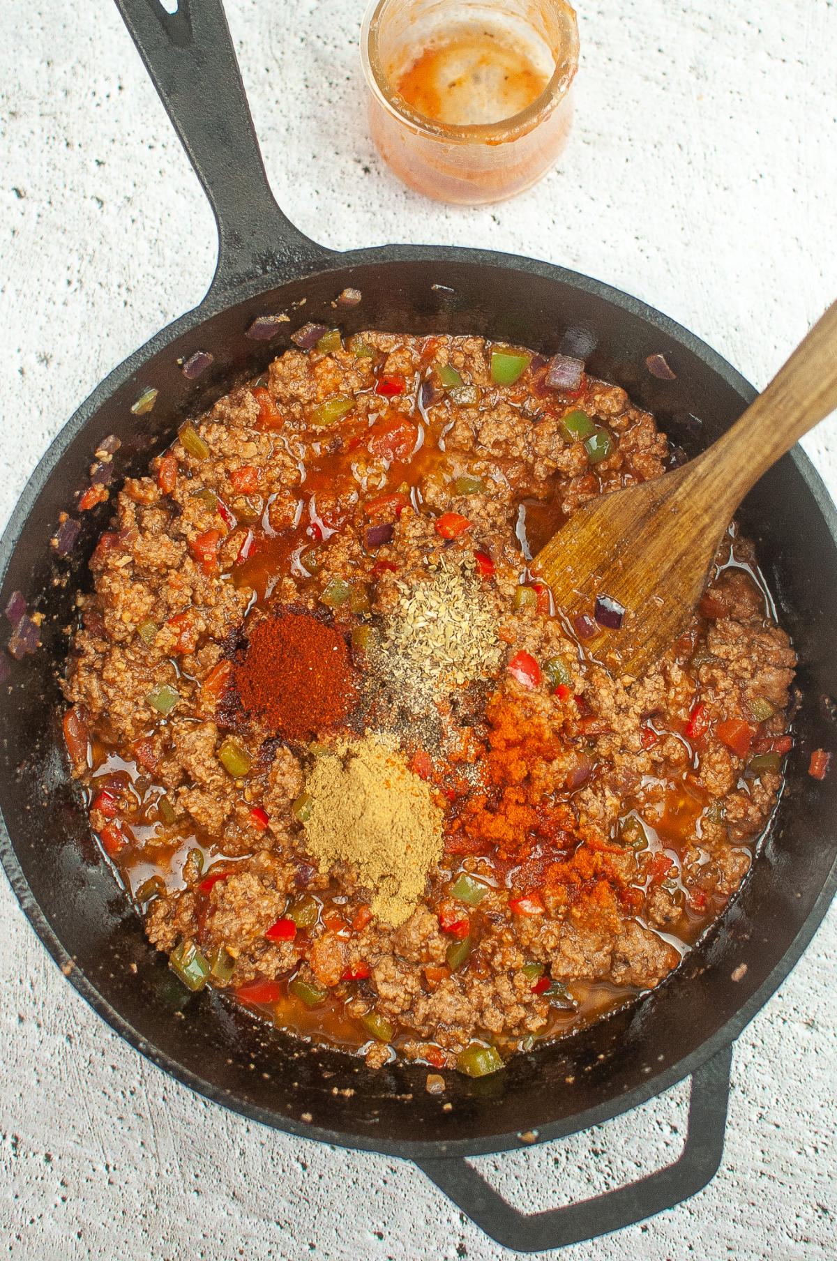 Spices are added to the ground beef mixture.