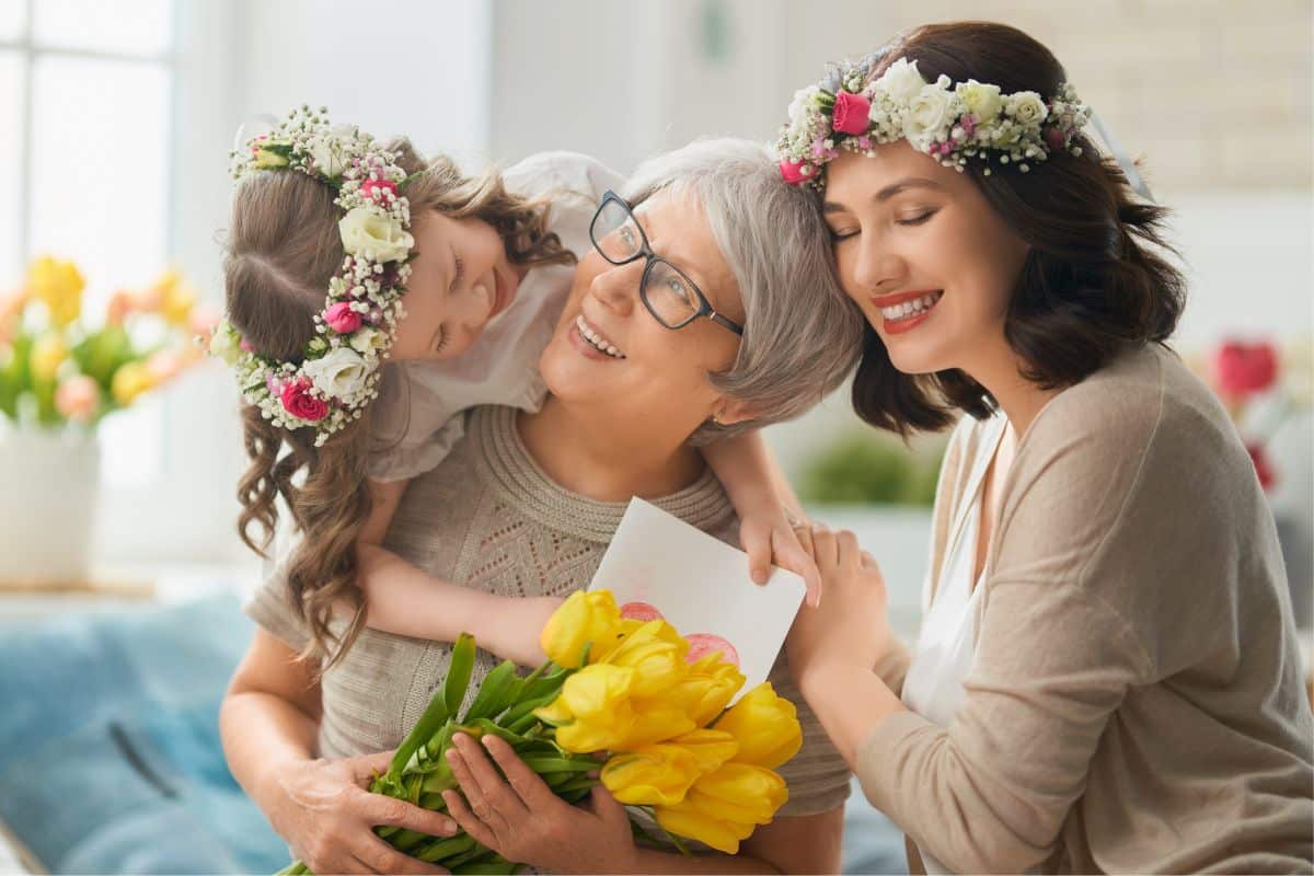 A mother, daughter and grandma holding a bouquet of tulips. 