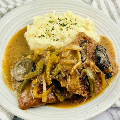 Slow Cooker Cube Steak with mushrooms and mashed potatoes.