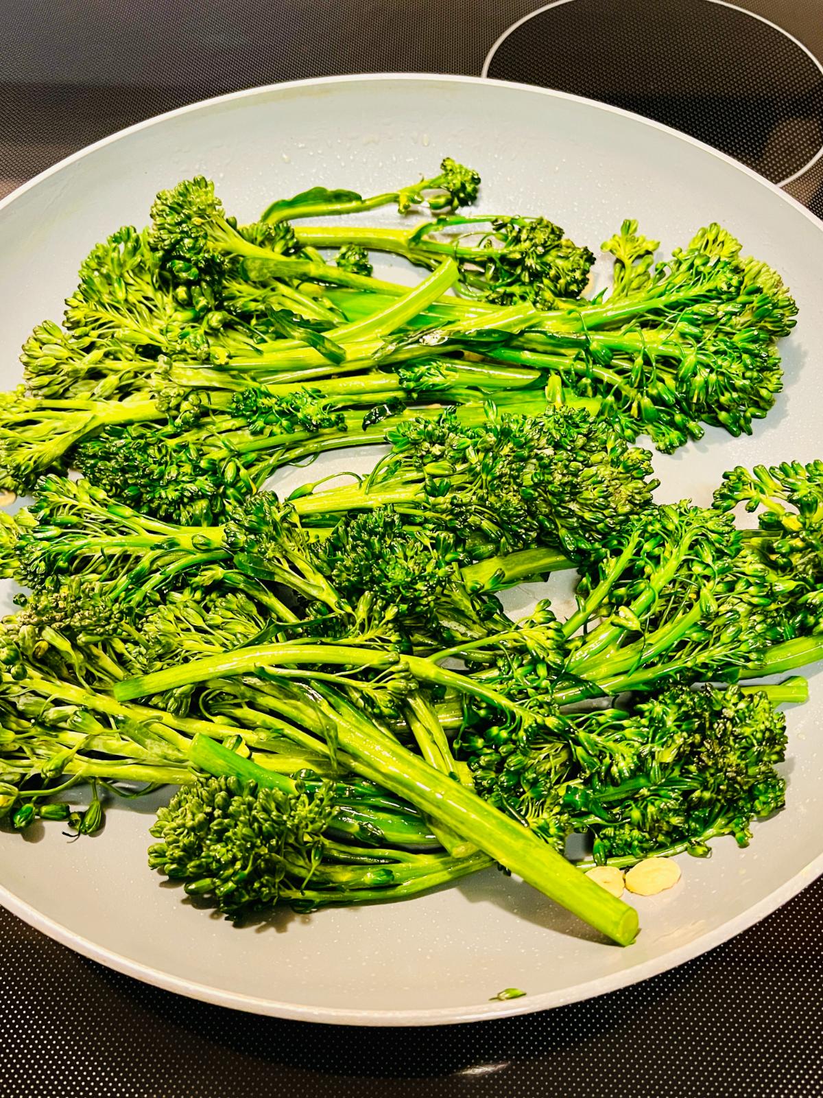 Fresh Tenderstem broccoli in a frying pan.
